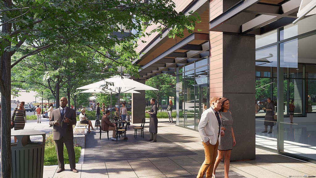 A man and woman kissing outside a building.